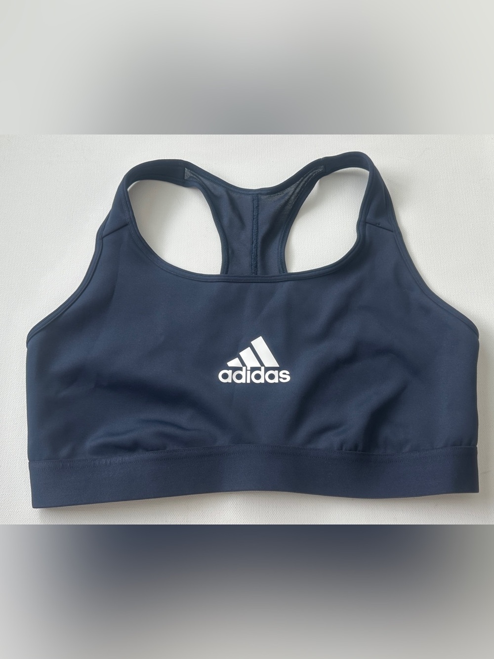 Adidas women’s Navy Blue Racerback Sports Bra with White Logo.  Size